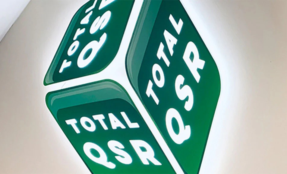 Metamark laminate vinyl protecting outdoor signage displaying Total QSR branding. 