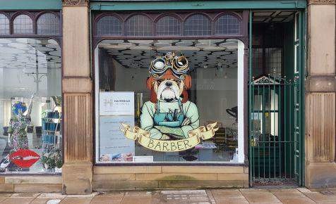Shop window graphic printed on vinyl, illustrating polymeric-vs-monomeric-vinyl applications for signage projects. 