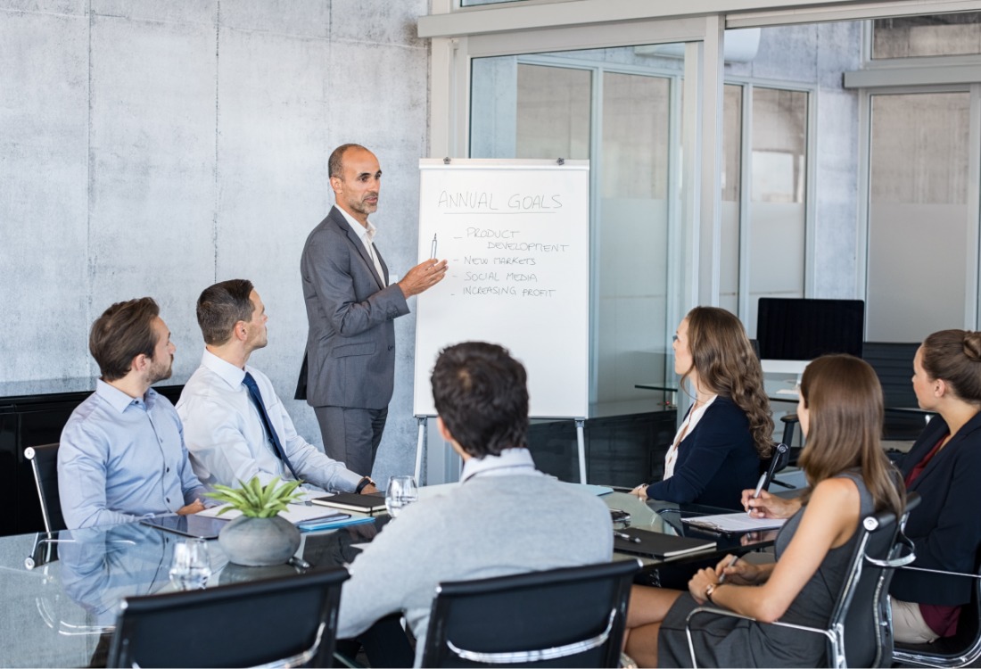 A leader shows different career paths to an audience, symbolising the diverse growth opportunities available for employees beyond traditional roles.