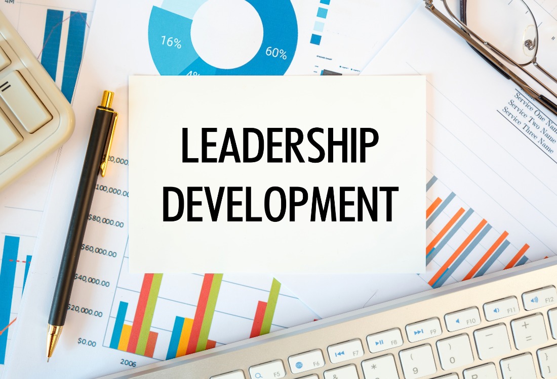 Leadership development is written in a document on the office desk, diagram and keyboard. 