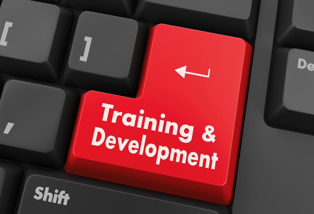 Red keyboard button emphasizing training and development programs requiring external support.