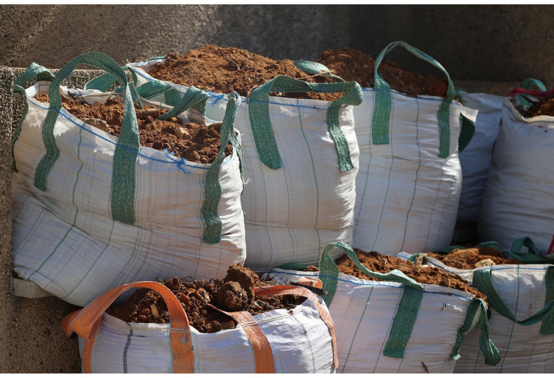 White FIBC bags being reused and recycled for builder's material for environmental protection and sustainability  