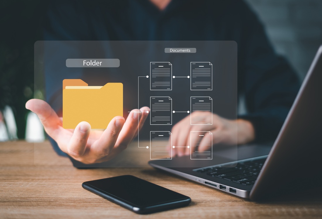 Electronic records management system with digital file folders displayed on a laptop, representing a client file management system.