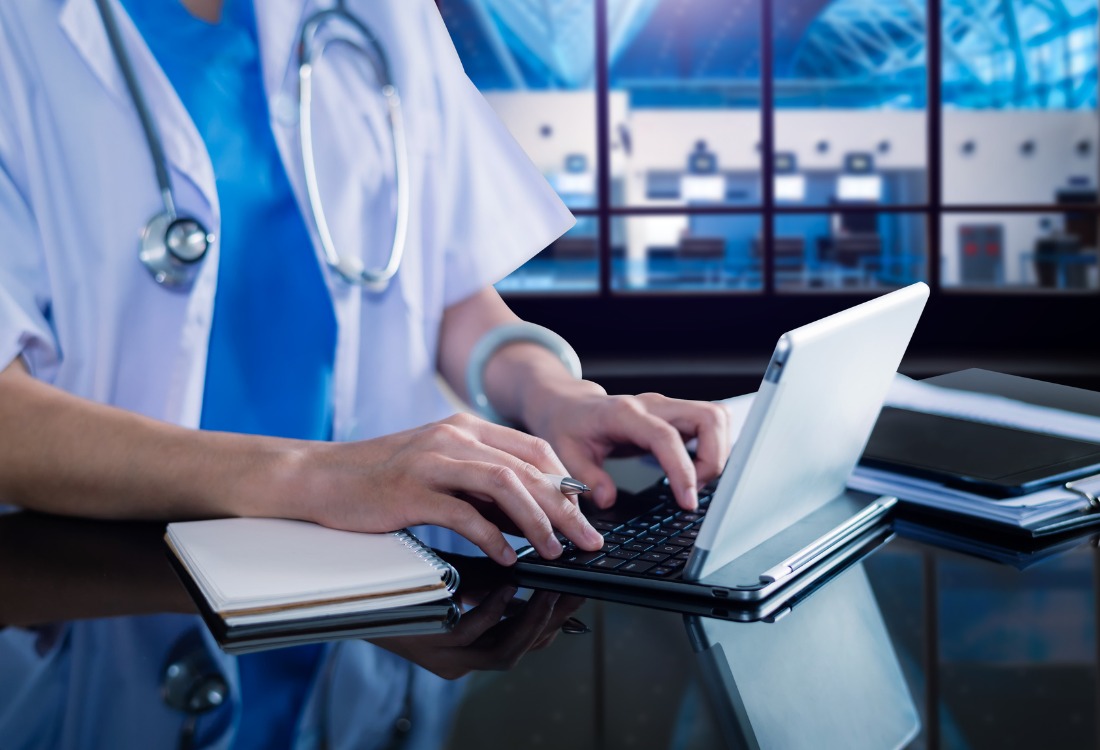 Doctor using workflow in healthcare system to register new patients. 