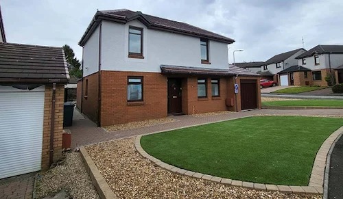 Modern two-storey house with a clean roof and a well-kept garden in a suburban neighbourhood.