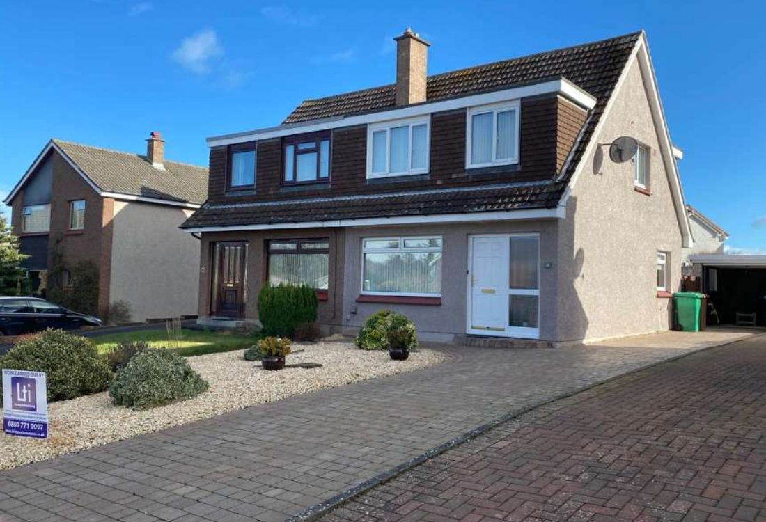 Residential home exterior showing roof tile refurbishment needs for coating or replacement