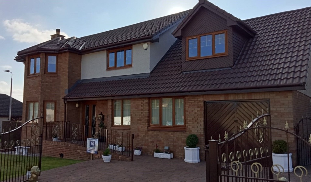 Scottish residential property with roof susceptible to moss in high-rainfall environment.