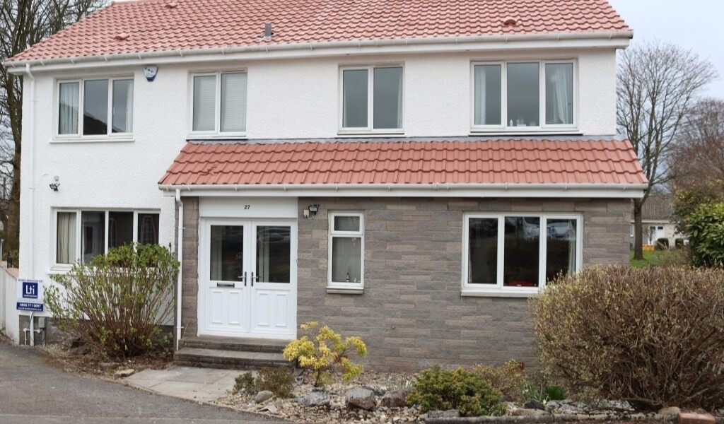 Terracotta roof coated with protective roof coating and polar white exterior wall finish.