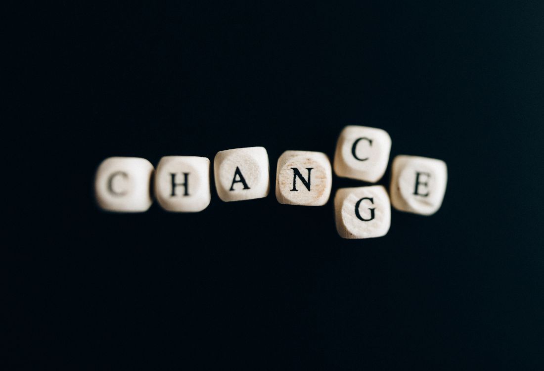 Letter tiles spelling the word ‘CHANGE’ arranged on a dark background.