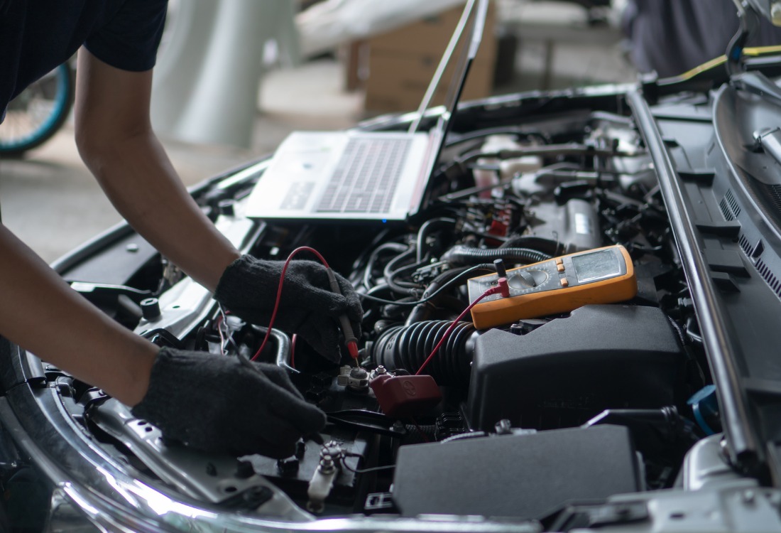 Open car hood showing engine bay during routine maintenance check as part of year round car maintenance guide.