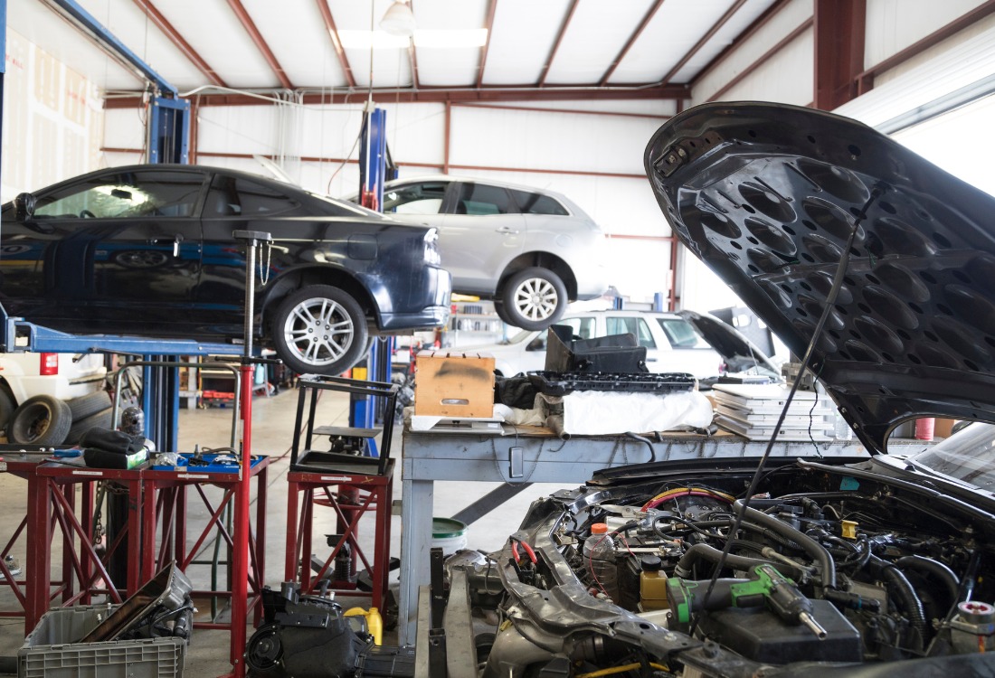 Cars being serviced in a garage by VBRA-accredited repairers, ensuring quality, safety, and professional vehicle repairs.