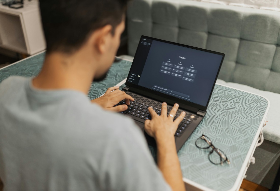 Man working with ChatGPT to generate images for large format printing and also utilisng AI generated images.