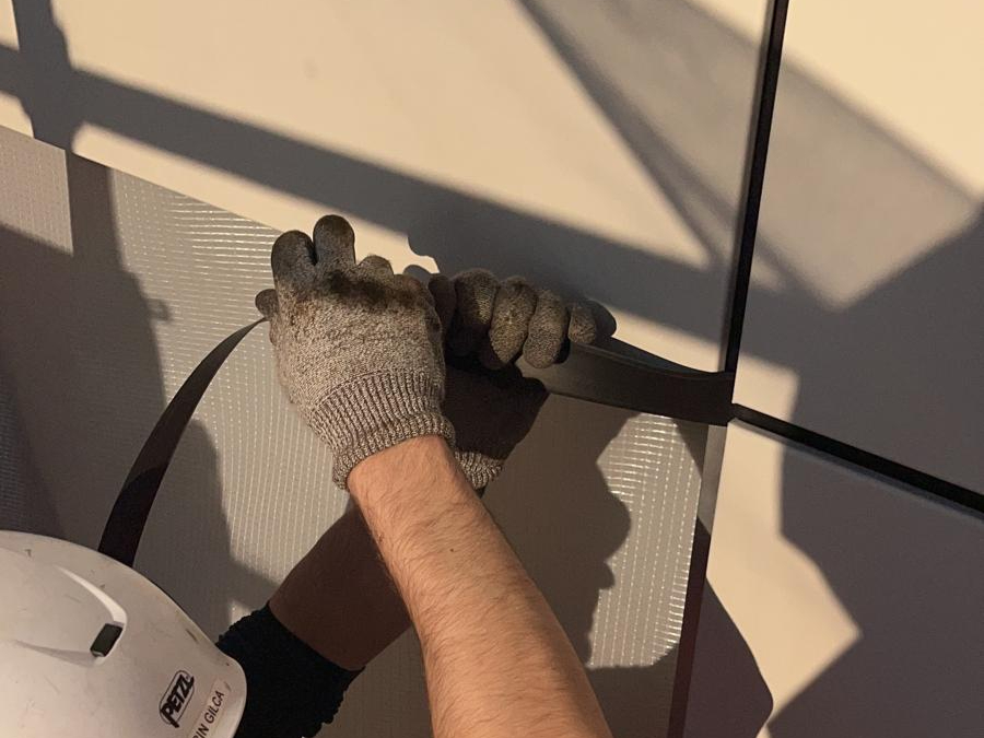 A contractor is installing a drained and ventilated rainscreen cladding. 