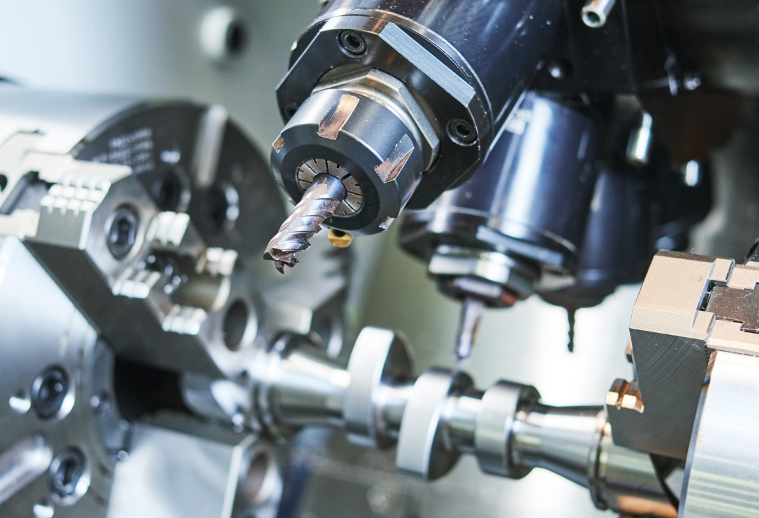Close-up of precision CNC machining tool working on a metal component, representing accuracy and compliance in manufacturing.