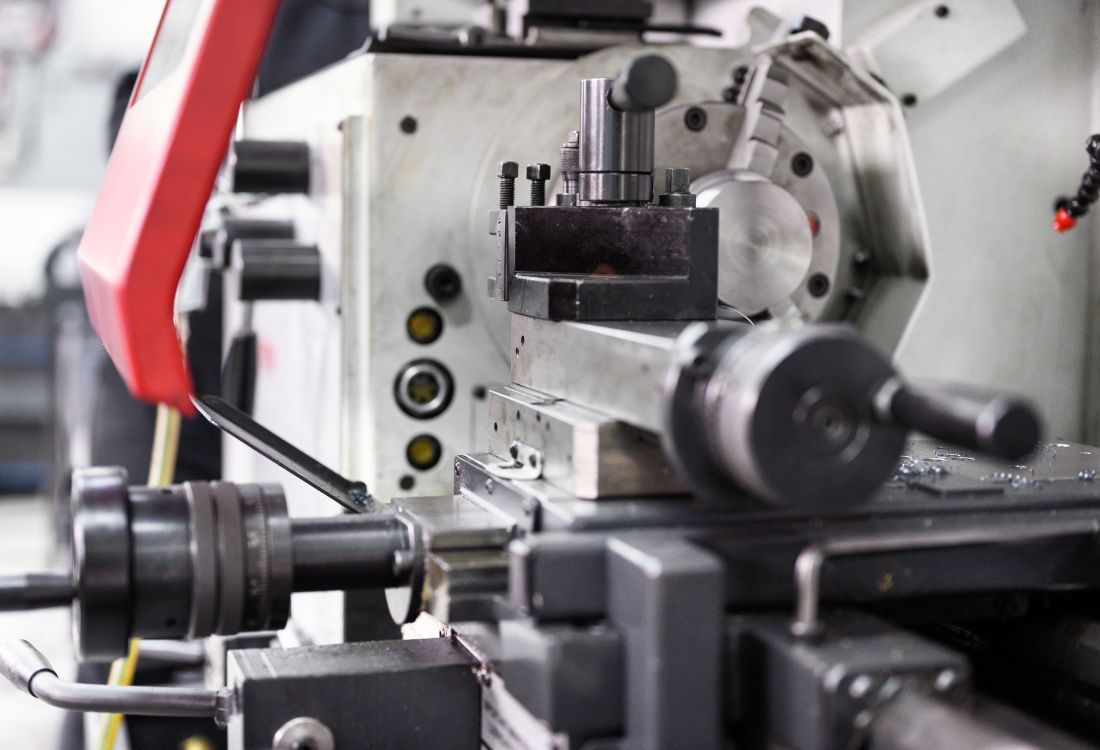 CNC lathe and milling machine components showing tooling and mechanical parts. 