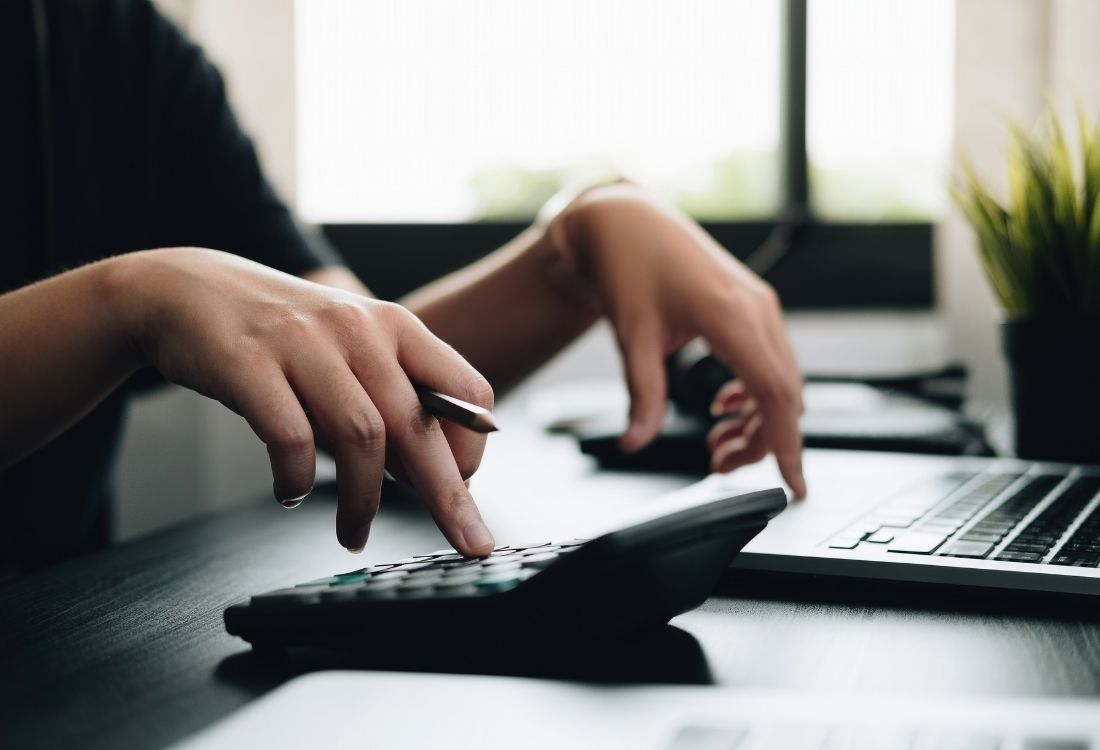 A business man, checking his finances to see whether the Management Development Programmes have been a good investment.