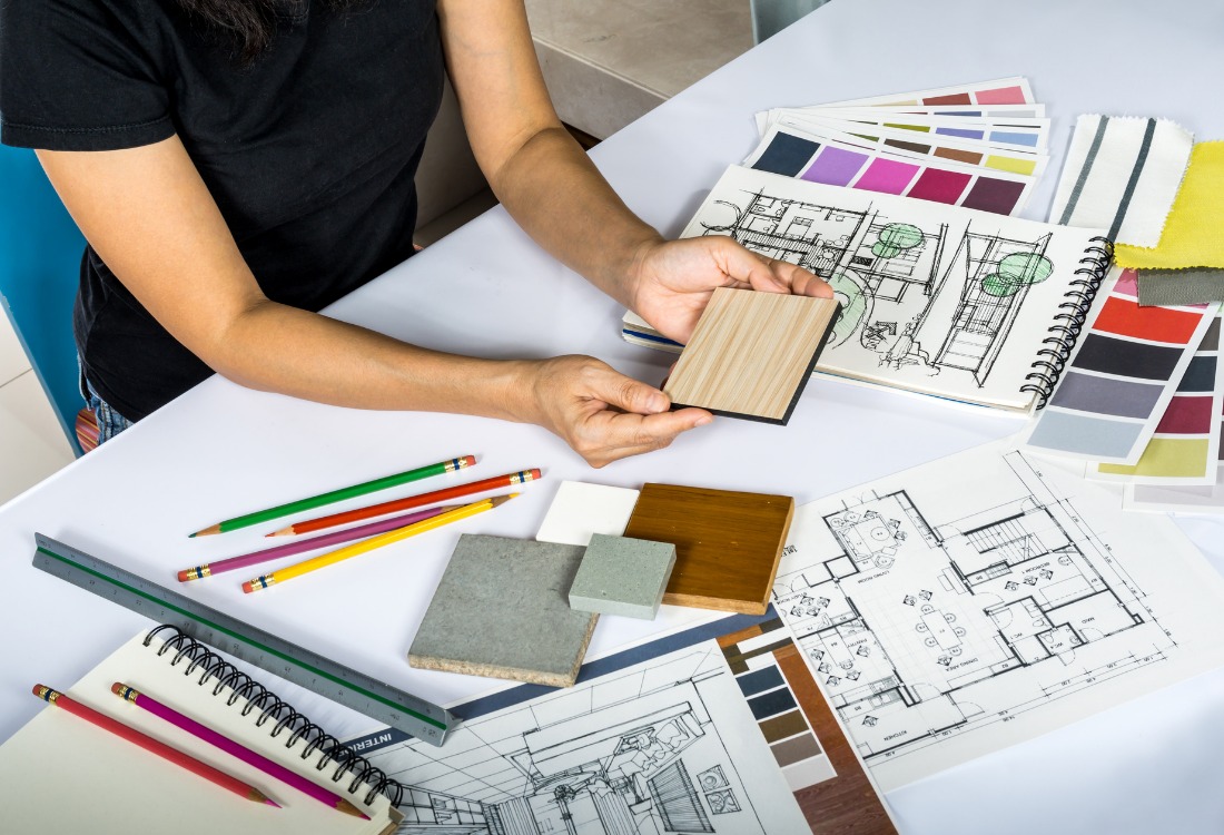 A woman working in architectural design choosing the best materials and colours to enhance user experience.