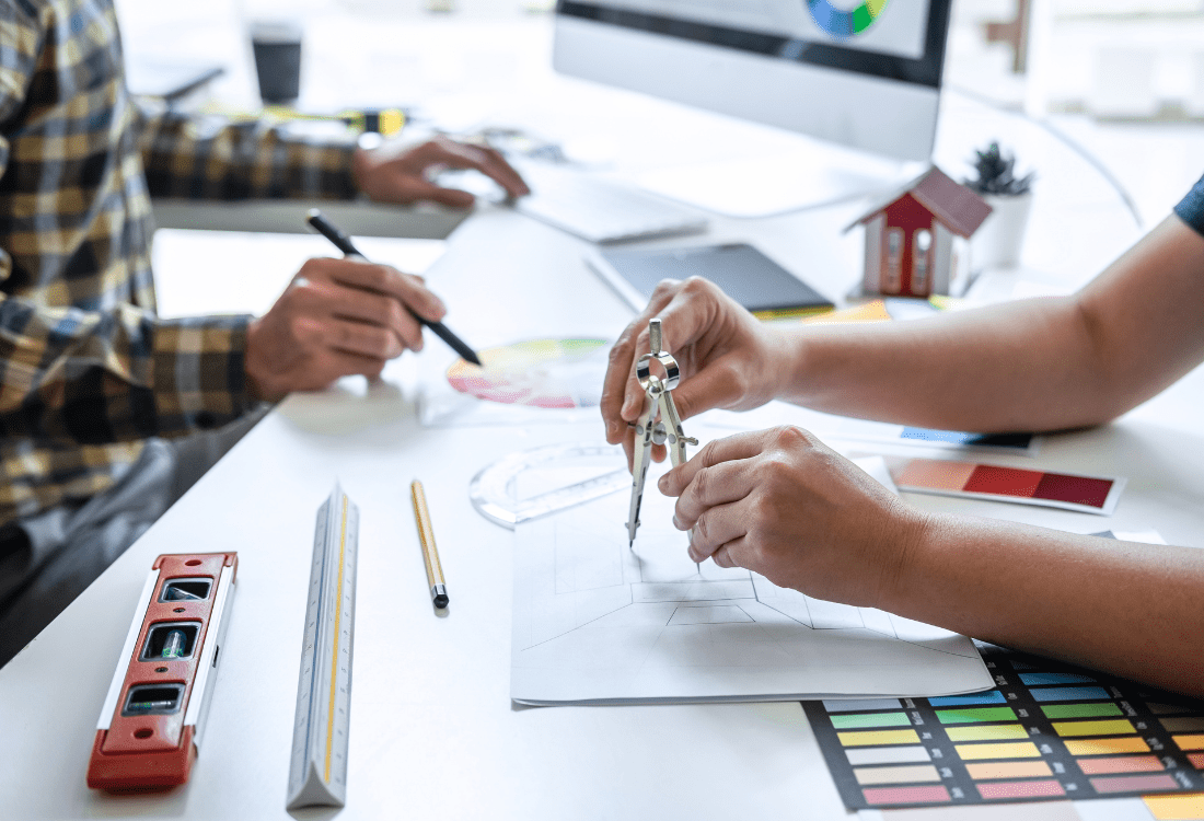 A commercial interior designer creating designs with a partner for a client.