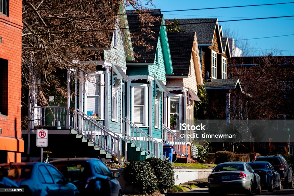 Multiple colorful houses in a row in a residential neighborhood in Portland Oregon. Shot on a sunny day in late January.