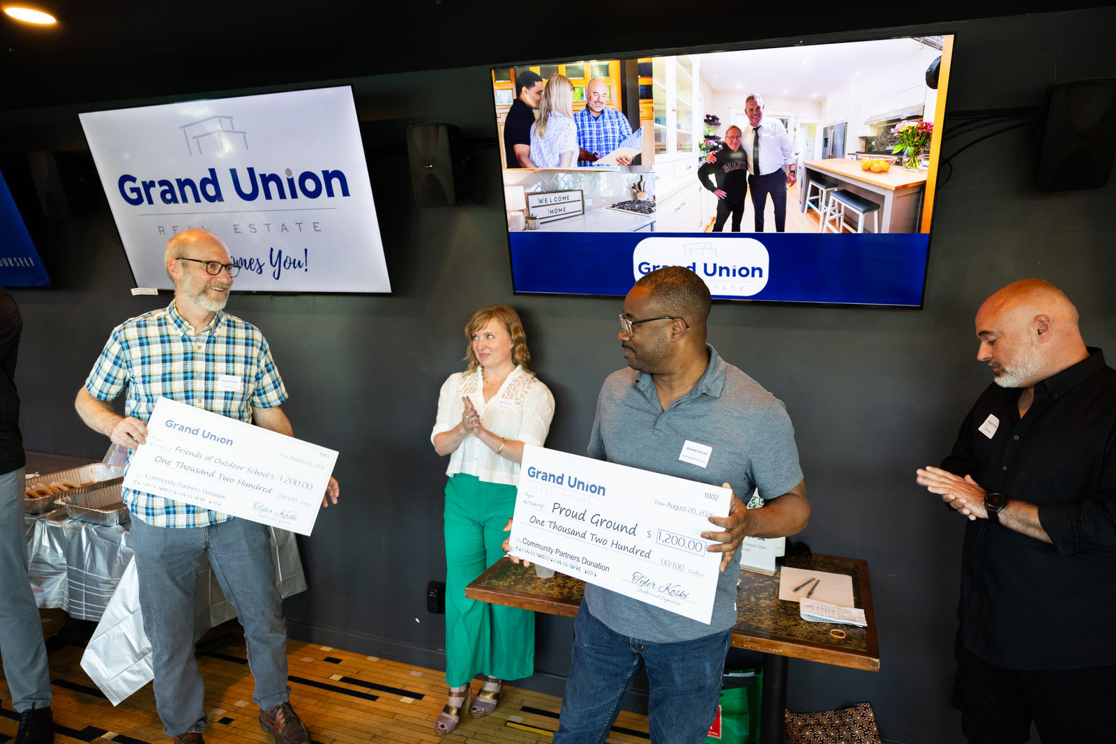 Grand Union presenting checks to Friends of Outdoor School and Proud Ground at the August launch