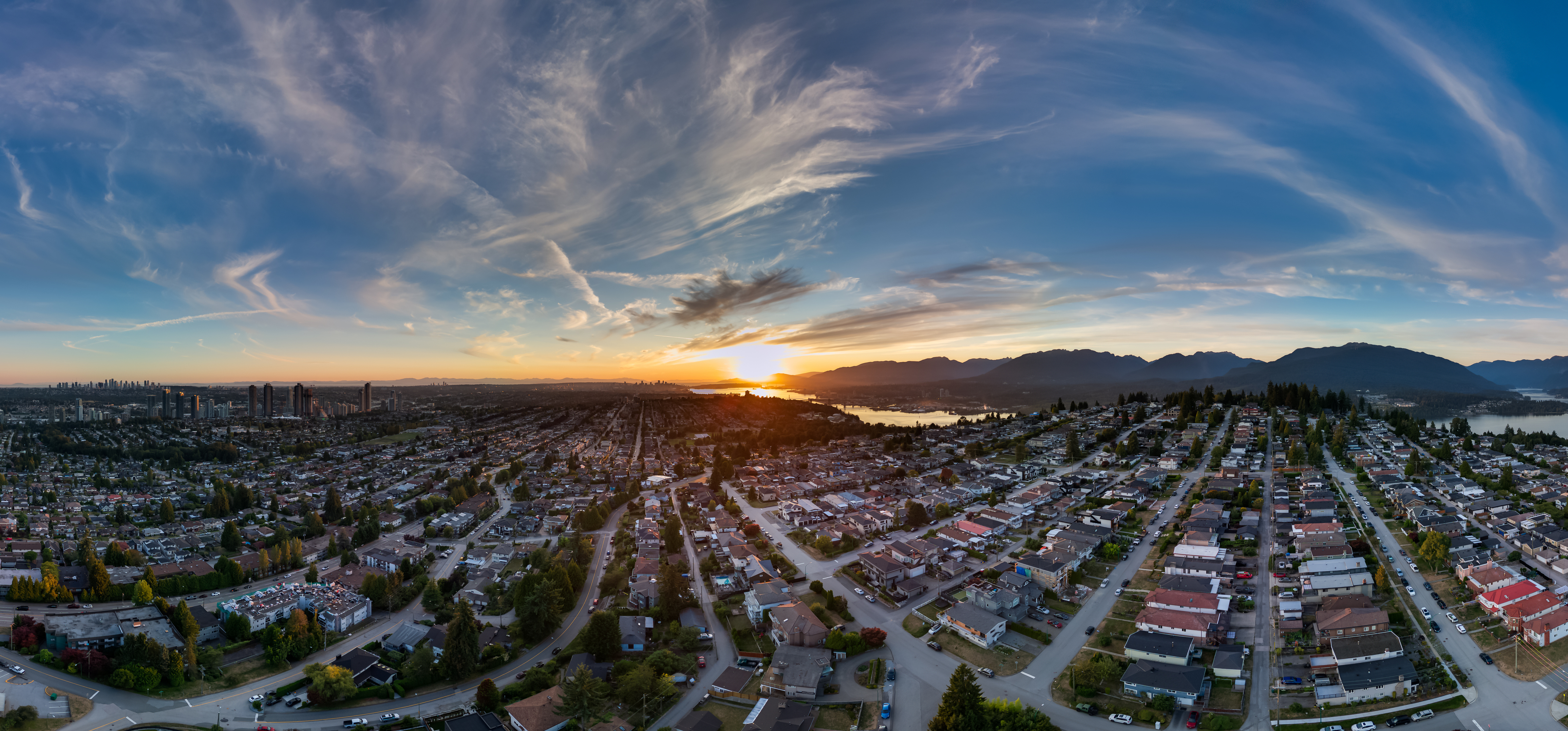 Vibrant urban aerial view with sunset sky over Burnaby, Greater Vancouver, BC.
