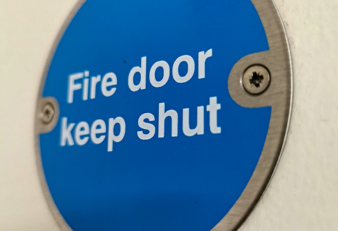Commercial fire doors that have been installed using fire-rated foam.