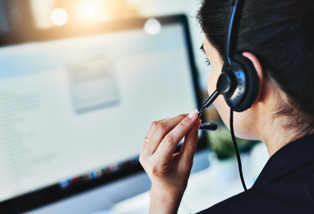 An experienced support agent working at a computer delivering responsive, personalised assistance and fast issue resolution provided by local managed IT services.