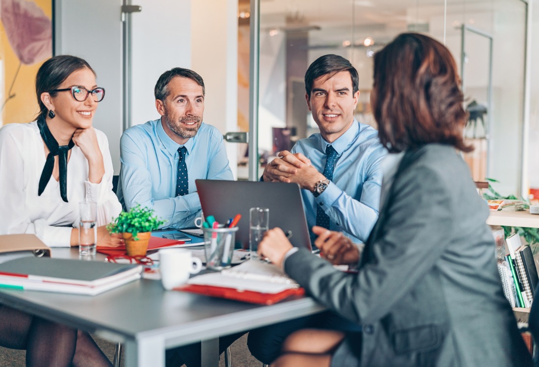 A team in a productive business meeting discussing strategy around a laptop, safe in the knowledge that they’re fully supported and protected by their choice to invest in IT service management.