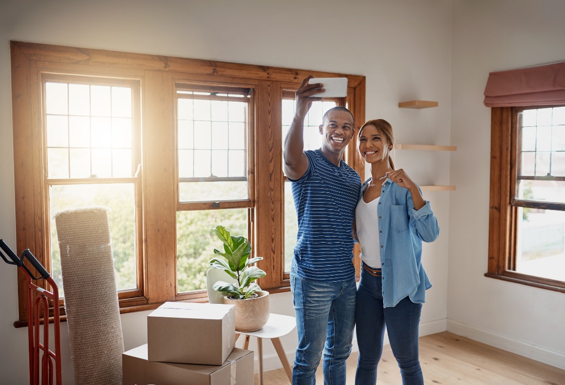 A couple celebrating getting a mortgage as 1st time buyers, which allowed them to purchase their first house.