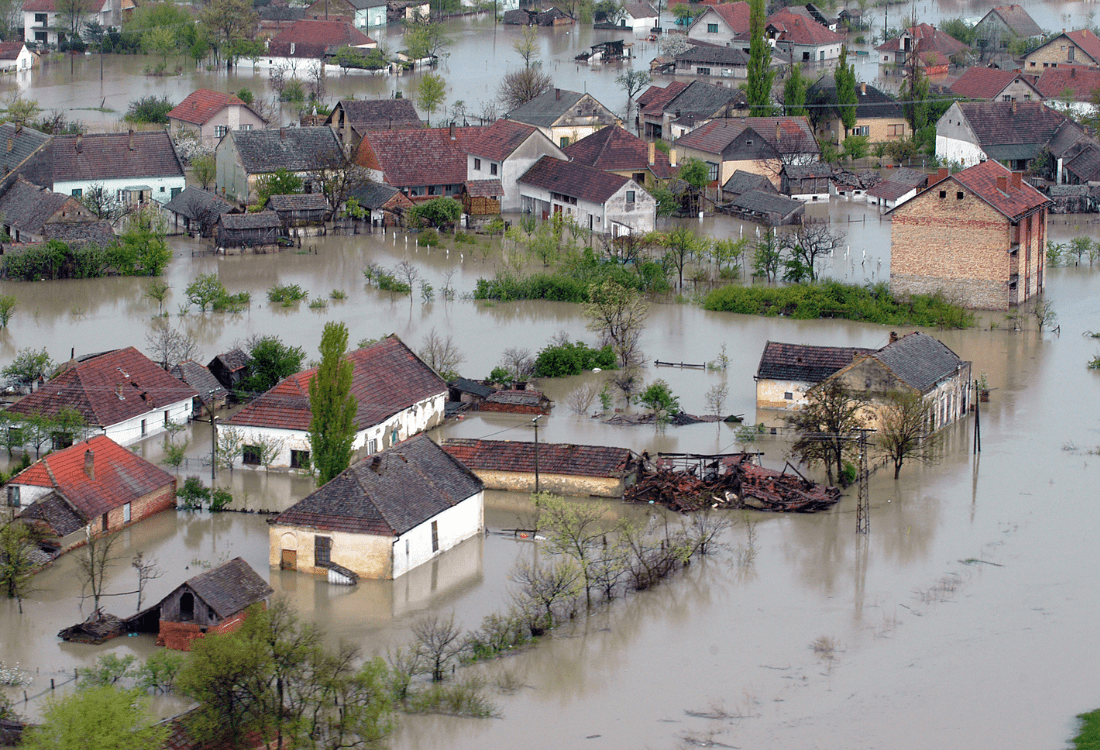 A picture of a flooded suburban British area with houses on the streets.