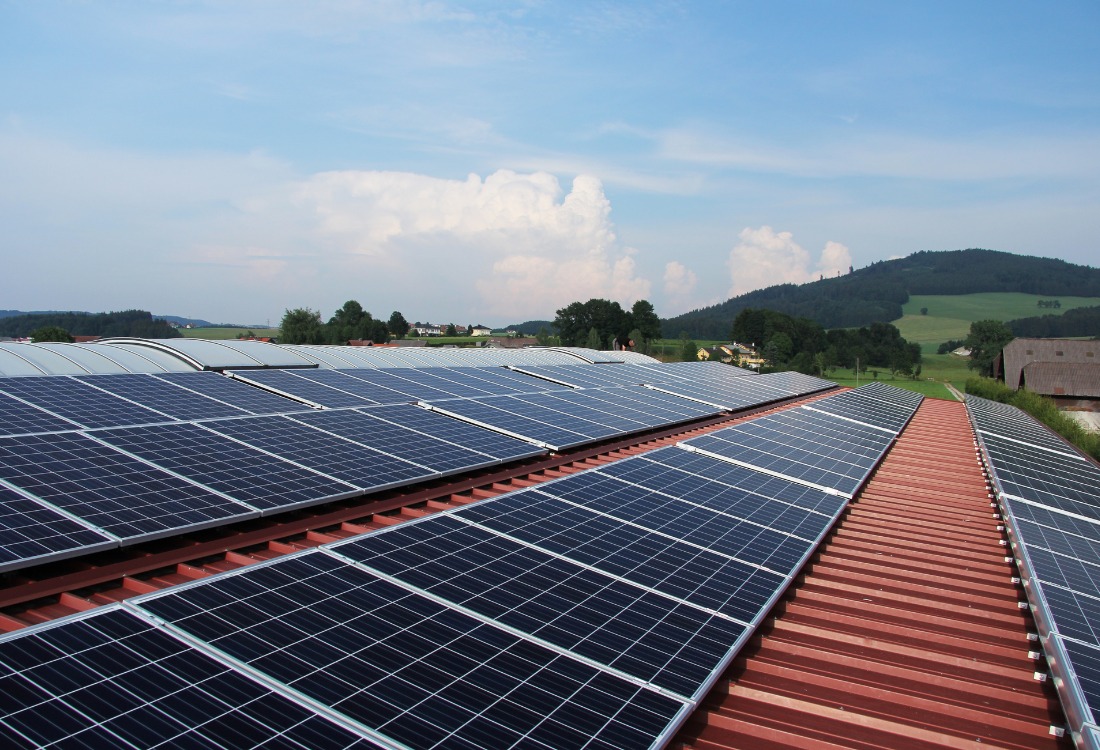 A solar panel array covering a warehouse roof, demonstrating long-term renewable energy infrastructure that delivers measurable financial returns over time.