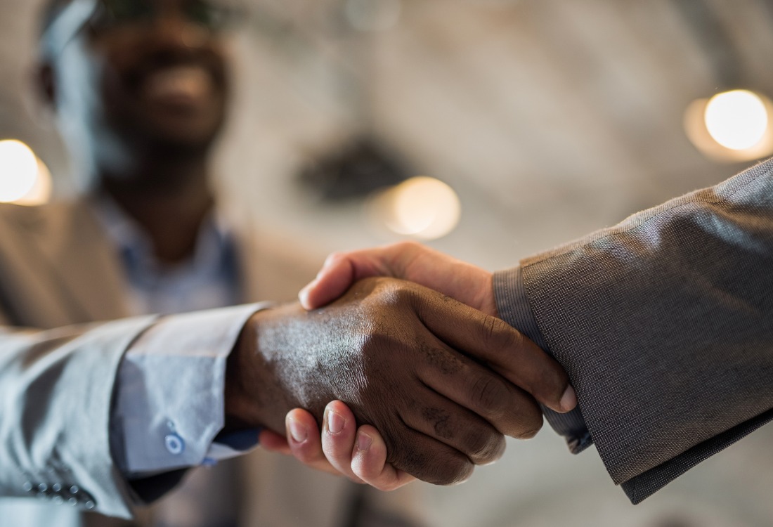 Two people shaking hands after agreeing that they are going to become their apprenticeship training provider.