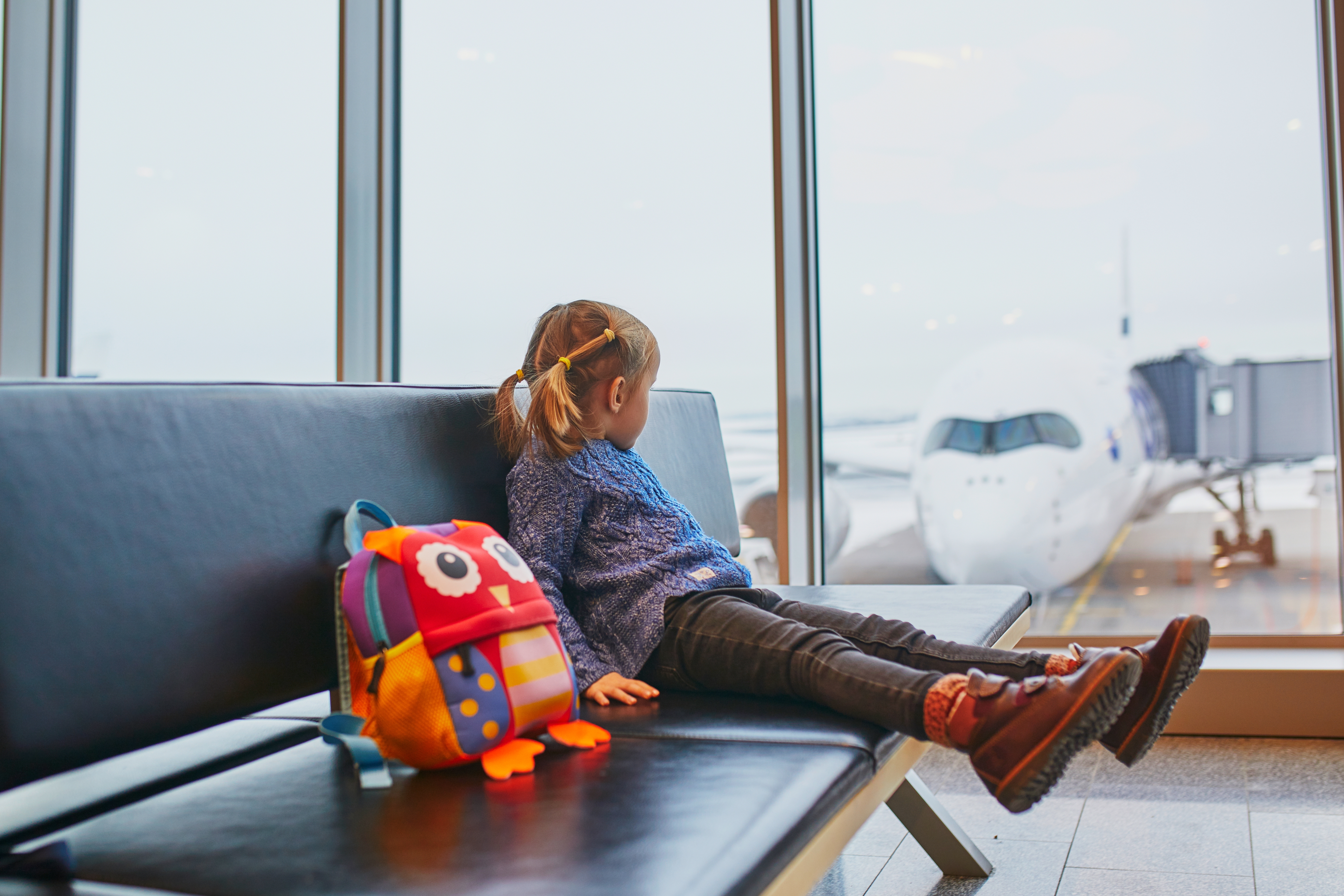 child looking at airport preparing for flight