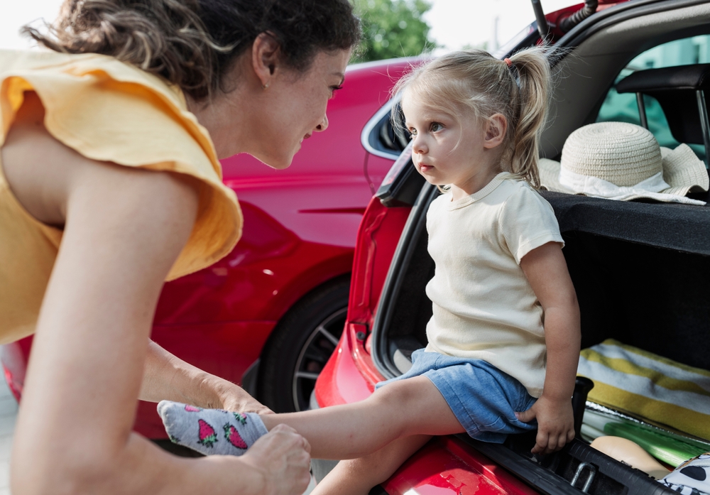 Bystander supporting parent setting boundary with child in public - helping parents hold limits