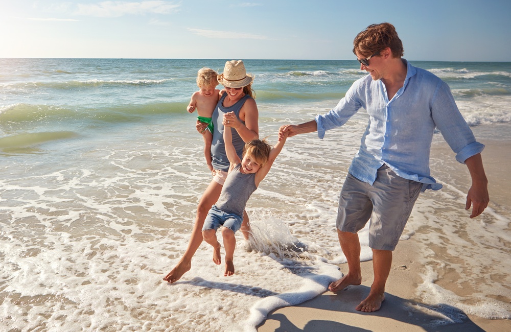 Bystander supporting families during beach rejection moment - child trying to make friends