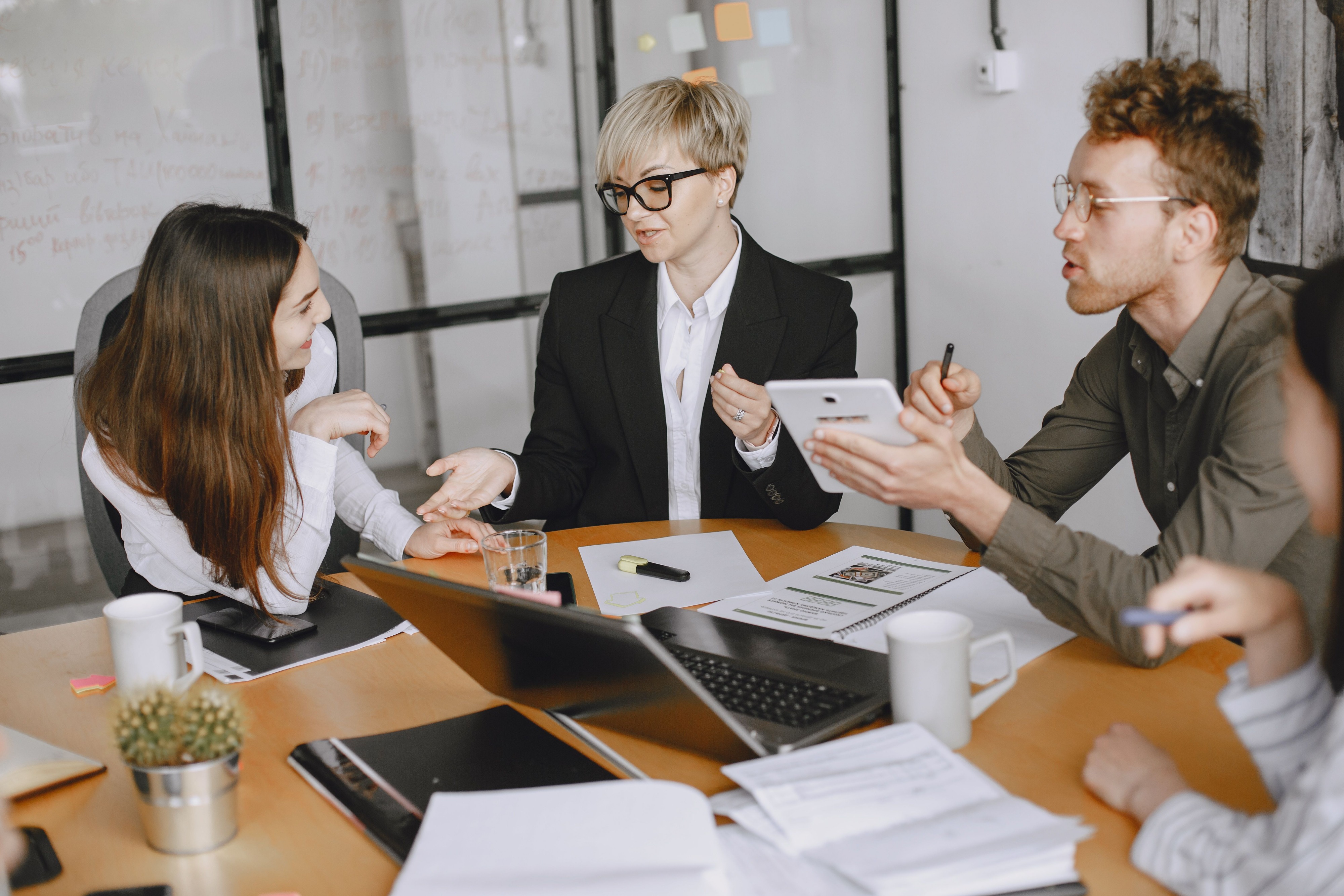 Staff discussing in-house vs outsourced QC.
