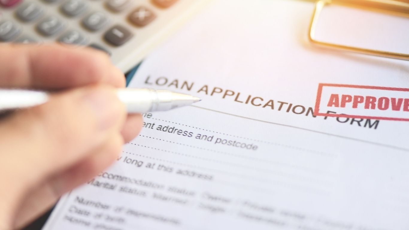 A professional reviewing financial paperwork at a desk for a Mortgage Audit.